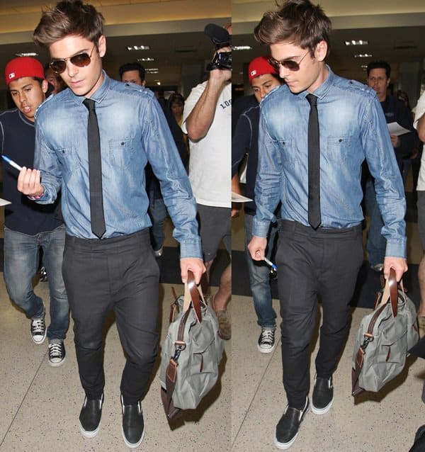 Zac Efron arriving to a fan and paparazzi frenzy at the LAX airport after flying in from New York City on July 27, 2010