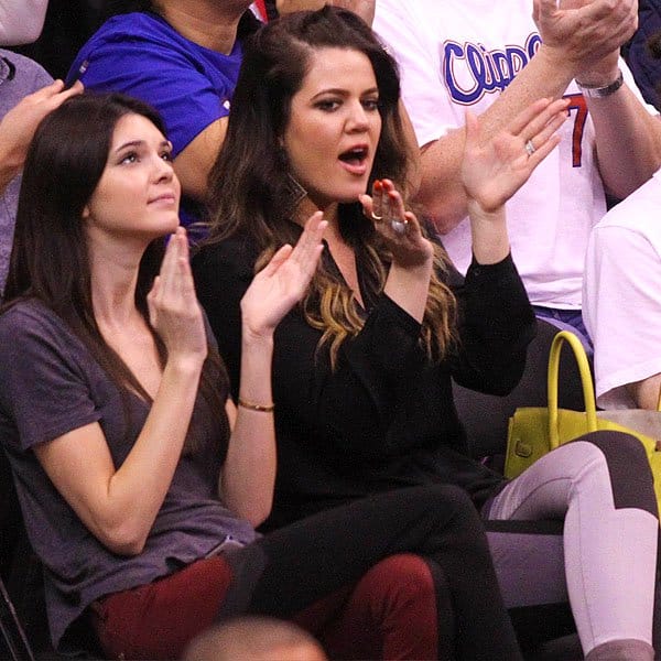 Kendall Jenner and Khloe Kardashian cheering in matching paneled jeans