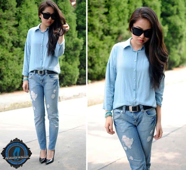 Meijia wearing a crisp button-down top with ripped jeans