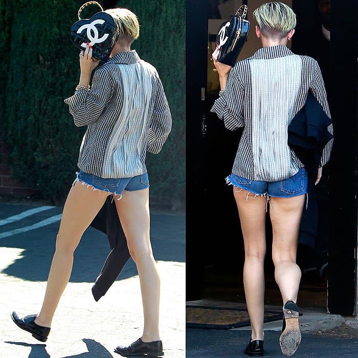Miley Cyrus showing off her heart shaped Chanel handbag and her legs in Levi's cutoff shorts