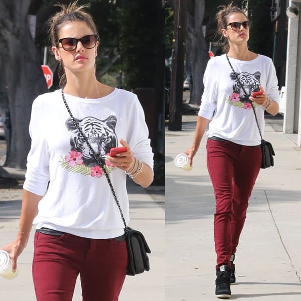 Alessandra Ambrosio was dressed in a tiger-print top and red jeans