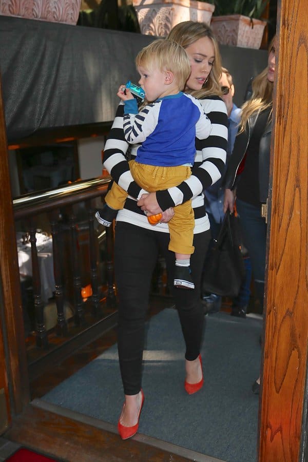 Hilary Duff carrying her son, Luca Comrie, in her arms as she leaves Madeos Restaurant in Los Angeles on October 15, 2013