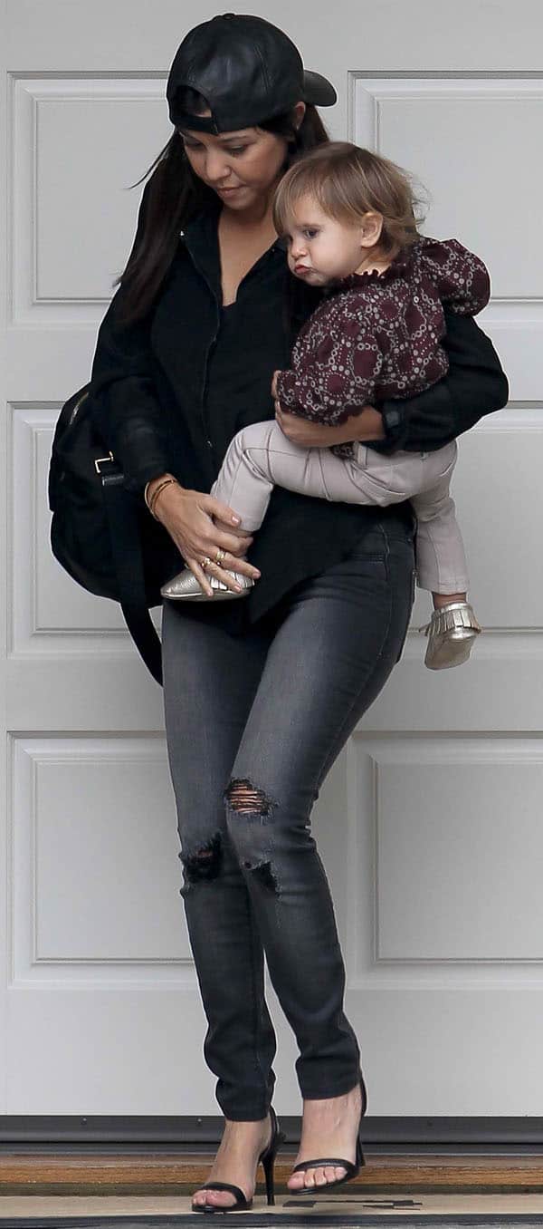 Kourtney Kardashian styled her jeans with a black Kymerah Ripley blouse