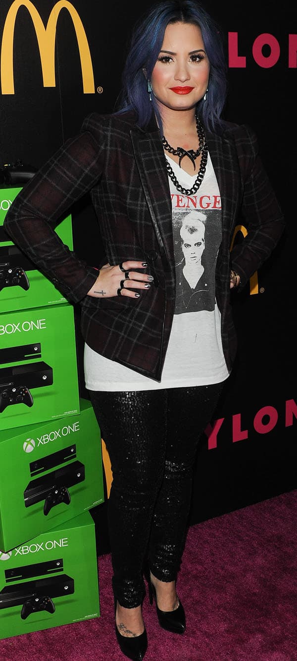 Demi Lovato posed beside what looked like a pile of unopened XBox One boxes