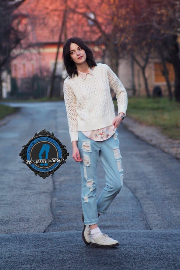 Nora styled her distressed blue jeans with a perforated sweater