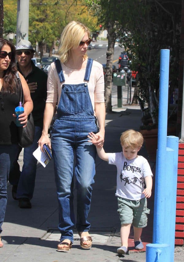 Wearing denim overalls and tortoiseshell sunglasses, January Jones enjoys a day out with her son Xander Dane Jones, who's wearing a Beatles T-shirt