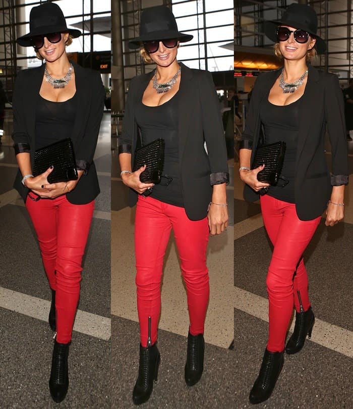 Paris Hilton flashes cleavage in red leather pants at Los Angeles International Airport (LAX)