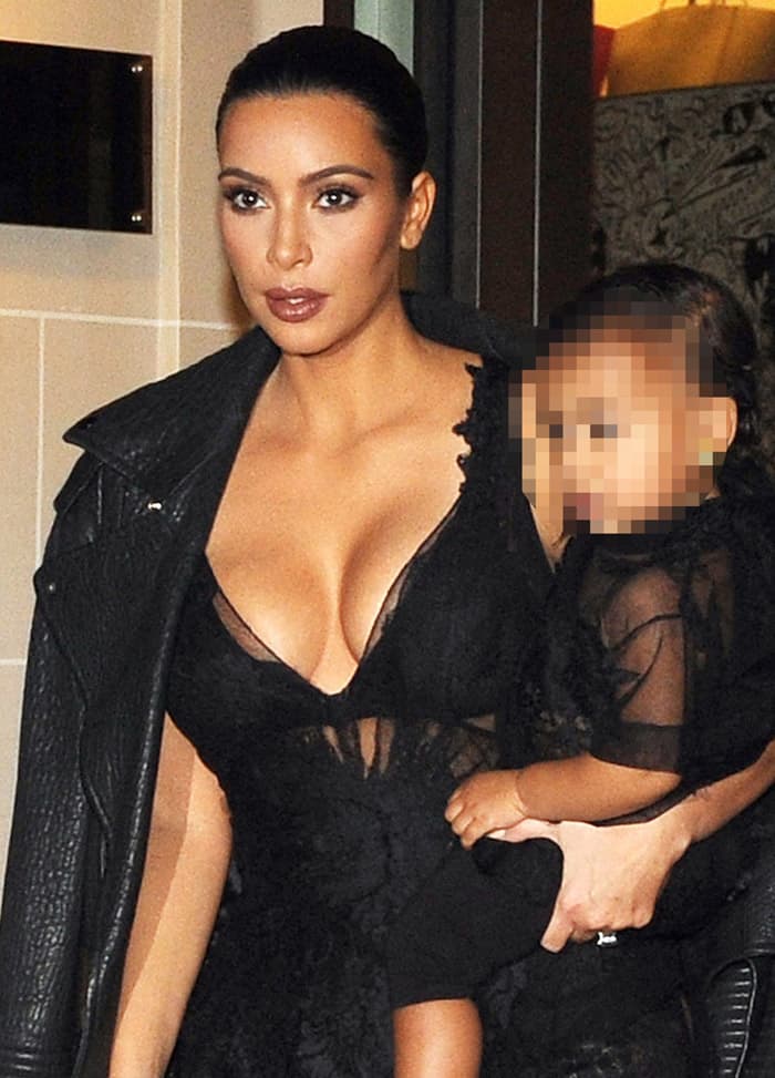 Kim Kardashian flaunted her well-endowed bust in the outfit but kept a semblance of modesty by draping a jacket over her shoulders
